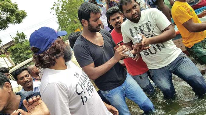 Vishal distributing food packets to flood victims. (Photo: DC) Vishal distributing food packets to flood victims. (Photo: DC)